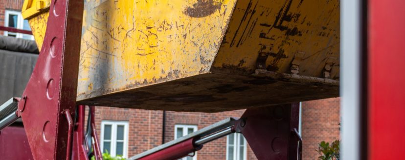 Big Yellow rubbish skip near the house. Rubbish removal hire during renovation of the house
