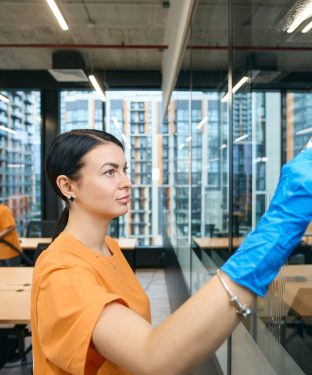 Employees cleaning company clean and disinfect surfaces in coworking space Qualified employees of the cleaning company clean and disinfect all surfaces in the coworking space